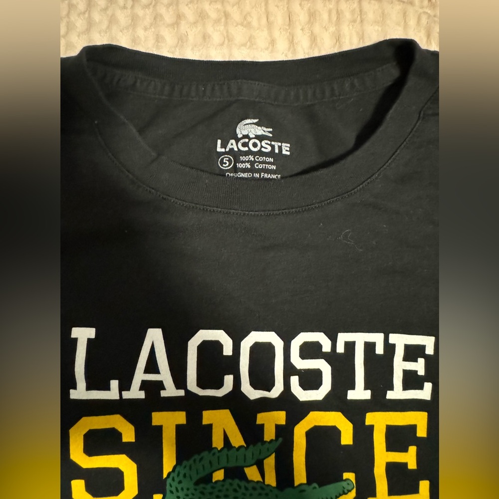 Black size 5 Lacoste tee shirt.